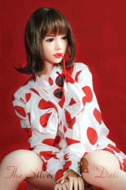 Daisy in white dress with red polka dots